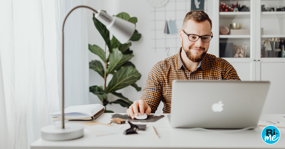 Man sitting at desk with laptop explaining bi me and business insurance